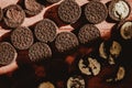 Delicate sweet chocolate oreo cookies on a wooden table on a beautiful sunny day