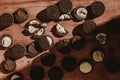 Delicate sweet chocolate oreo cookies on a wooden table on a beautiful sunny day