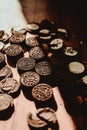 Delicate sweet chocolate oreo cookies on a wooden table on a beautiful sunny day