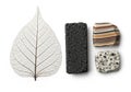 A delicate, translucent leaf skeleton is positioned next to three stones. The first stone is Royalty Free Stock Photo
