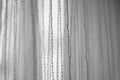 Delicate tulle with vertical threads pattern, side view, bw photo
