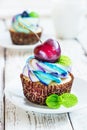 Delicate vanilla cupcakes with cream and berries on a white wooden background Royalty Free Stock Photo