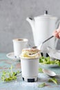 Delicate vanilla soufflÃÂ© in ramekin with icing sugar, hot coffee and fresh mint. Delicious French dessert to the coffee