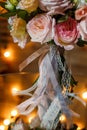 Delicate and very beautiful wedding bouquet of roses, greenery, eustoma standing on mirror table. Bridal trendy flowers