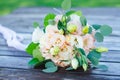 Delicate wedding bouquet of cream, white, green roses, pale pink eustoma flowers and green leaves. Royalty Free Stock Photo