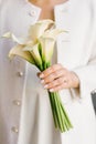 Delicate white bouquet of calla lilies in the hands of the bride at the wedding Royalty Free Stock Photo