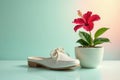 A delicate white mule rests beside a vibrant hibiscus in a pristine pot, a study in contrasts and quiet elegance. Generative AI Royalty Free Stock Photo
