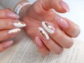 Delicate white and pink manicure with gold design. Shiny gold design.