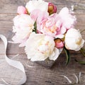 Delicate white pink peony with petals flowers and white ribbon on wooden board. Overhead top view, flat lay. Copy space. Birthday, Royalty Free Stock Photo