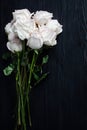 Delicate white roses on black wooden background close up, beautiful light pink flowers bouquet on dark gray wood, greeting card Royalty Free Stock Photo