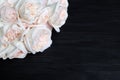 Delicate white roses on black wooden background closeup, beautiful light pink flowers bouquet on dark wood, birthday greeting card Royalty Free Stock Photo