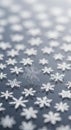 Delicate white snowflake decorations are scattered across a smooth, reflective Royalty Free Stock Photo