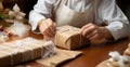 Delicate wrapping: Close-up reveals confectioner\'s hands carefully adorning cardboard box with finesse.