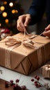 Delicate wrapping: Close-up reveals confectioner\'s hands carefully adorning cardboard box with finesse.