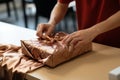 Delicate wrapping: Up-close hands adeptly prepare and enclose the item with precision.