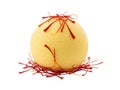 A delicate yellow easter egg adorned with red saffron threads and tied with string on a black background Royalty Free Stock Photo