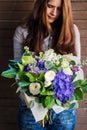 Delicate young woman with flowers bouquet
