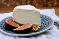 Delice de Bourgogne French cow\'s milk cheese from Burgundy region of France served with fresh figs and walnuts