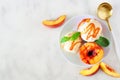 Delicios grilled peaches with vanilla ice cream, top view table scene on a white marble background Royalty Free Stock Photo