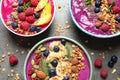 Delicious acai smoothie with toppings in bowls on table
