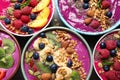 Delicious acai smoothie with toppings in bowls on table