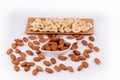 Delicious almond nuts in white bowl and cashew nuts in wooden bowl the basket