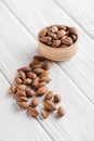 delicious almonds in wooden bowl on white