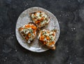 Delicious appetizer, tapas - baked pumpkin, gorgonzola, honey, thyme bruschetta on a dark background, top view