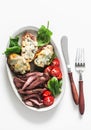 Delicious appetizer, tapas, lunch plate - beef steak, vegetables salad and roasted potatoes with blue cheese on a light background Royalty Free Stock Photo
