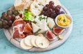 Delicious appetizer to wine - ham, cheese, grapes, crackers, figs, nuts, jam Royalty Free Stock Photo