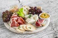 Delicious appetizer to wine - ham, cheese, grapes, crackers, figs, nuts, jam Royalty Free Stock Photo