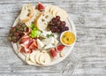Delicious appetizer to wine - ham, cheese, grapes, crackers, figs, nuts, jam Royalty Free Stock Photo