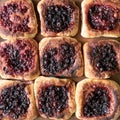 Delicious, appetizing hot pies with berry filling, cooked in a Russian oven, close-up. Hearty snack. Traditional cuisine
