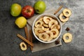 Delicious apple chips, fresh fruits, anise and cinnamon on grey table, flat lay