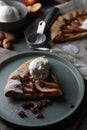 Delicious apple galette with ice cream and pecans on wooden table Royalty Free Stock Photo