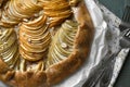 Delicious apple galette with walnuts and forks on table, top view