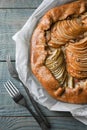 Delicious apple galette with walnuts and forks on wooden table, flat lay