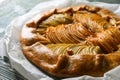 Delicious apple galette with walnuts on wooden table, closeup