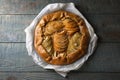 Delicious apple galette with walnuts on wooden table, top view