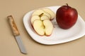 Delicious apple and slice in white plate with knife and fork Royalty Free Stock Photo
