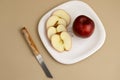 Delicious apple and slice in white plate with knife and fork Royalty Free Stock Photo