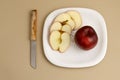 Delicious apple and slice in white plate with knife and fork Royalty Free Stock Photo