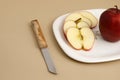 Delicious apple and slice in white plate with knife and fork Royalty Free Stock Photo