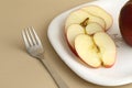 Delicious apple and slice in white plate with knife and fork Royalty Free Stock Photo