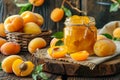 Delicious apricot jam and fresh rolls on a wooden table with whole and halved apricots