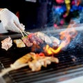 Delicious Asian Cuisine meat Satay Cooking on a Hot Charcoal Grill with smoke Royalty Free Stock Photo