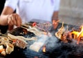 Delicious Asian Cuisine meat Satay Cooking on a Hot Charcoal Grill with smoke Royalty Free Stock Photo