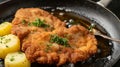 Delicious authentic breaded and deep-fried Wiener schnitzel served with lemon and mashed potatoes on a a plate Royalty Free Stock Photo