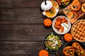 Delicious autumn meal side border. Overhead view on a dark wood background. Royalty Free Stock Photo