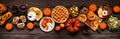 Delicious autumn meal table scene. Top down view on a dark wood banner background. Royalty Free Stock Photo